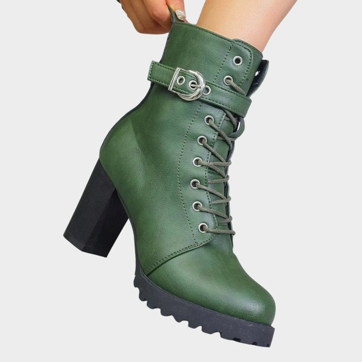 High-quality women's black combat boots. Features robust block heel, classic lace-up front & buckle detail.