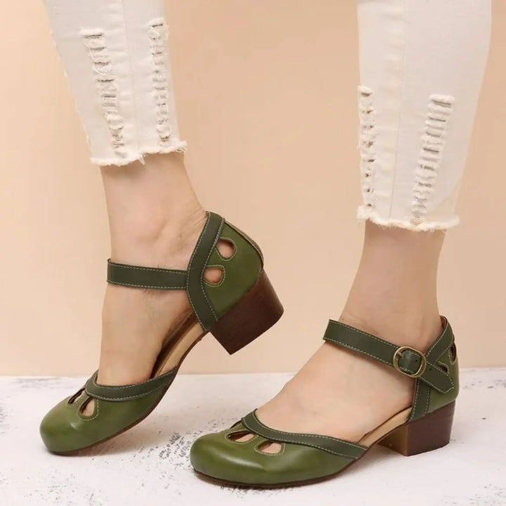 Stylish women's Mary Jane flats with secure ankle strap & charming cutout details, offering comfortable, casual wear.