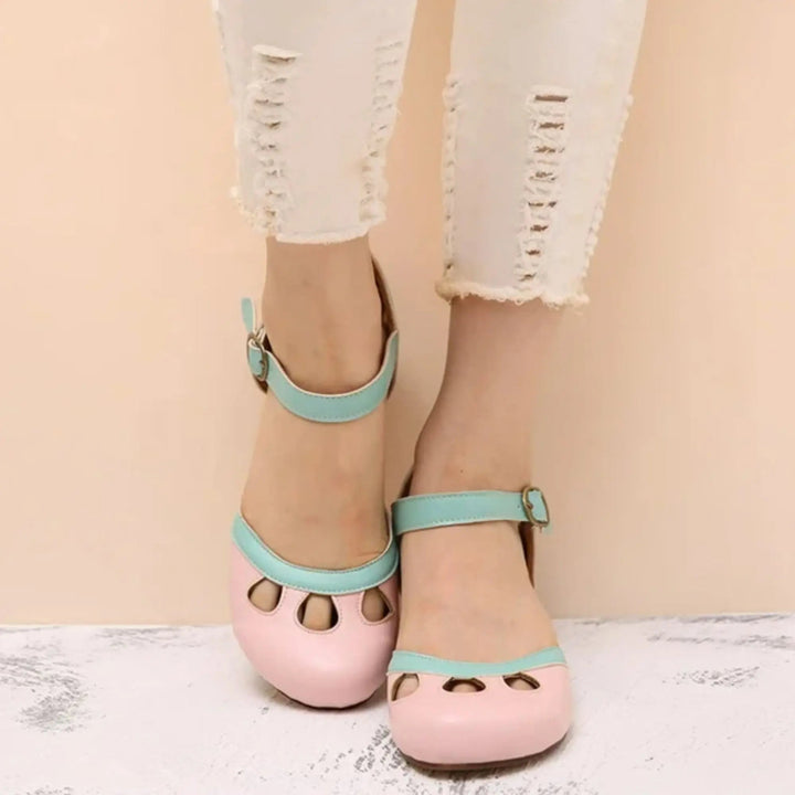 Vintage-style women's Mary Jane flats with rounded toe, ankle strap, and delicate cutout detail for everyday comfort.
