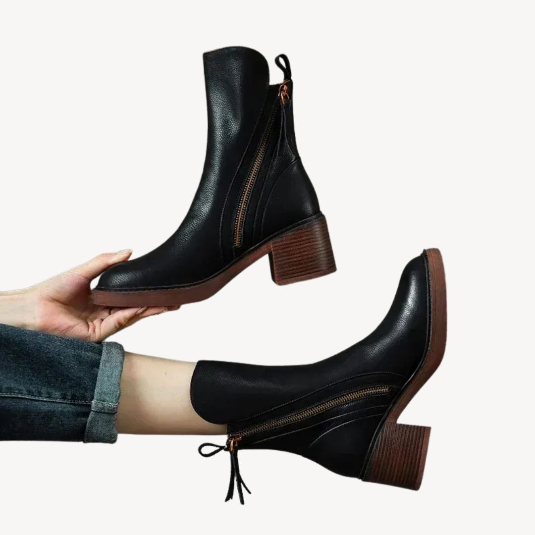 Women's black orthopedic ankle boots with side zipper, offering comfort & style for fall and winter.