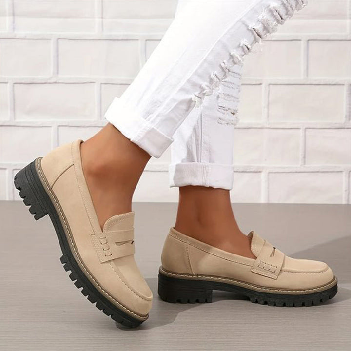 Women's black platform loafers with a chic vamp strap & chunky sole for elegant casual style.