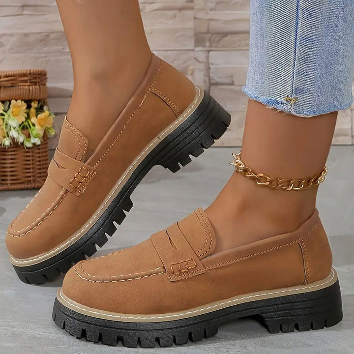 Stylish women's footwear: platform loafers with a chic vamp strap and a comfortable chunky sole.