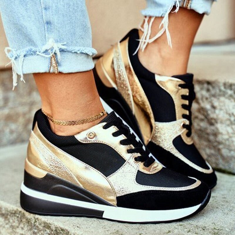 Women's black platform sneakers with gold metallic accents, comfortable street style fashion footwear.