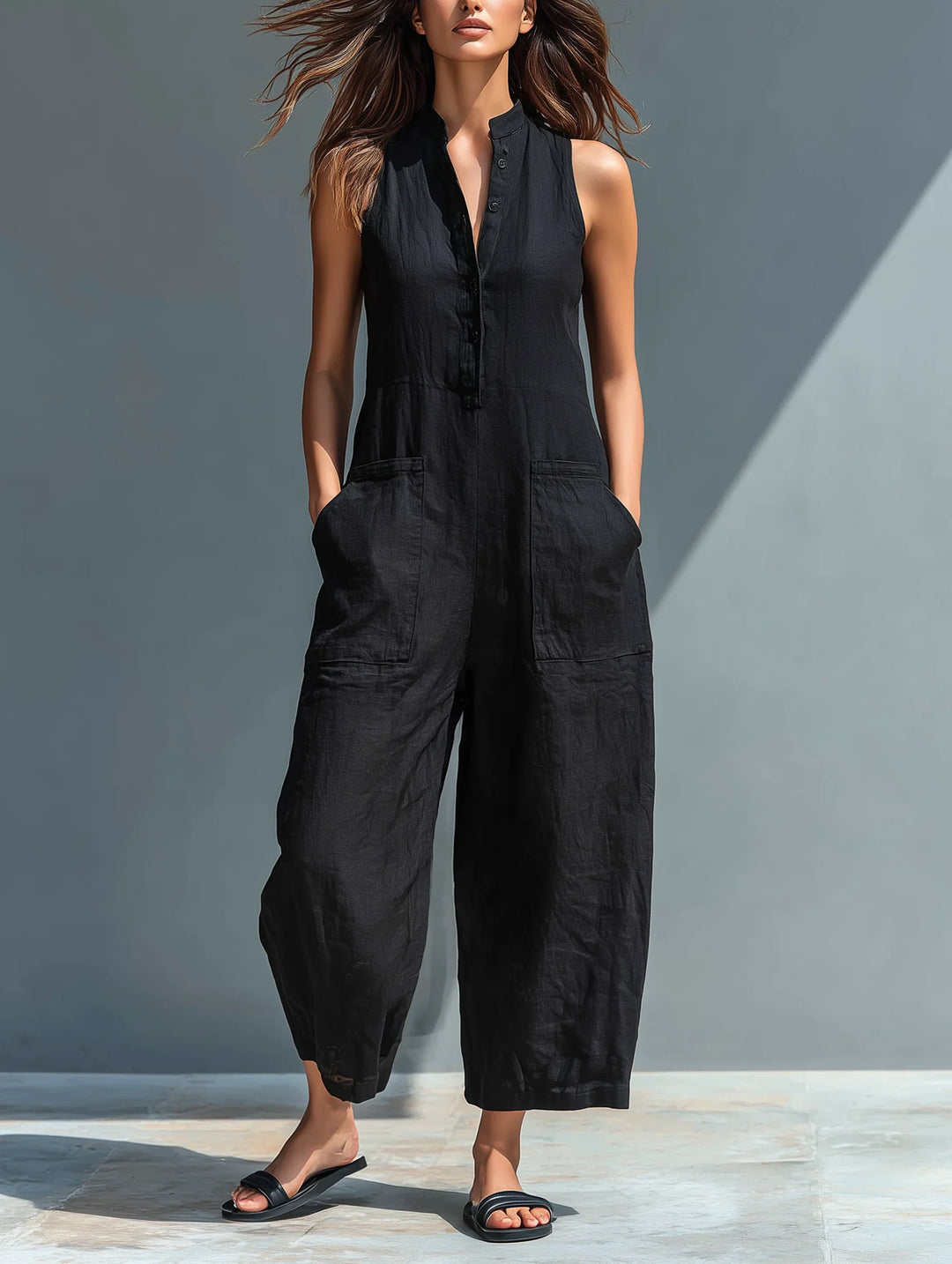 Women's black wide-leg sleeveless jumpsuit with mandarin collar. Elegant & comfortable summer fashion.