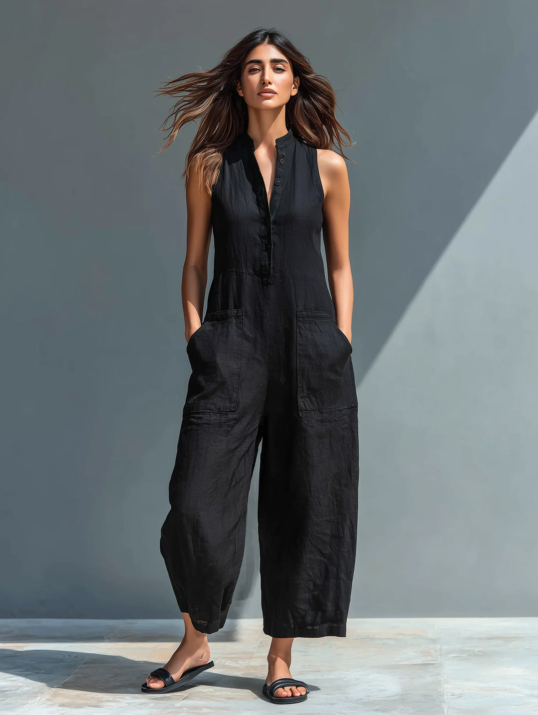 White sleeveless wide-leg jumpsuit for women, featuring a crisp mandarin collar. Ideal for summer elegance.