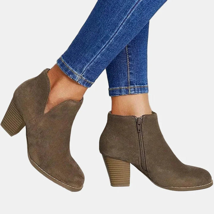 Stylish women's stacked-heel ankle boots with a practical side zip closure, versatile for any winter outfit.