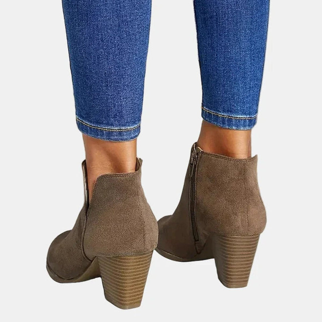 Fashionable women's block-heel booties featuring a side zip, offering a comfortable and chic footwear option.
