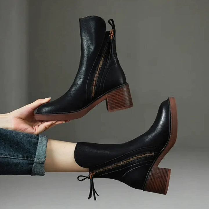Chic women's block-heel ankle boots with side zip. Comfortable design for fall fashion and winter warmth.