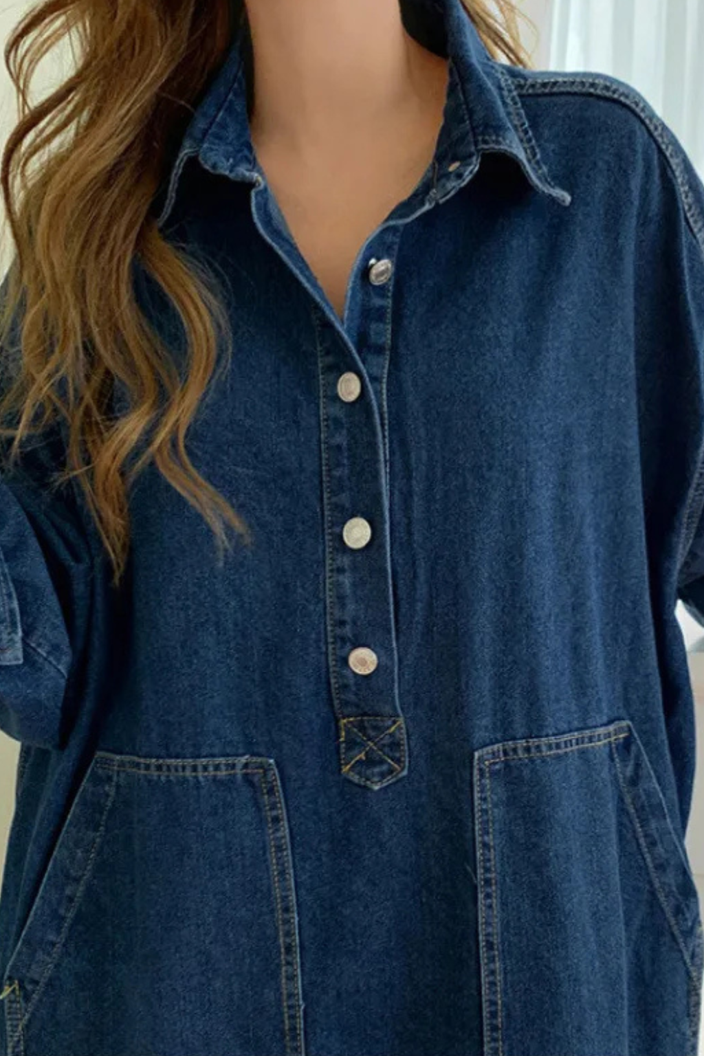 Stylish woman wearing a blue long sleeve collared maxi dress with pockets, ideal for transitional seasons.