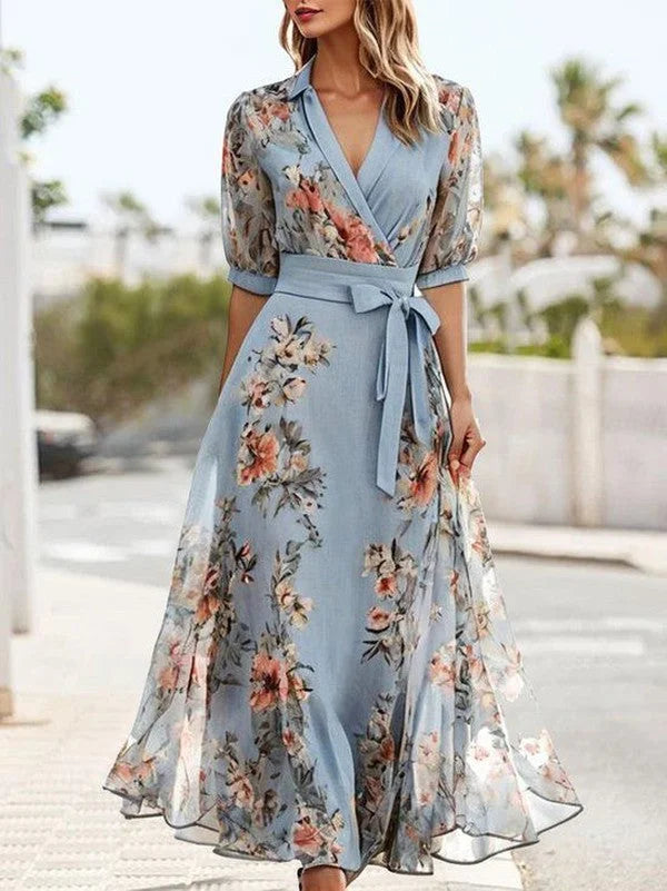 Women's blue floral midi dress featuring V-neck, tie-waist, and puff sleeves. Ideal for elegant summer style.