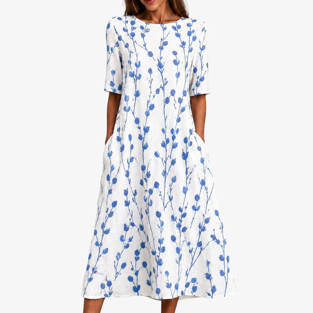 Women's blue floral midi dress with pockets. Breezy botanical print, comfortable and elegant for summer & spring.