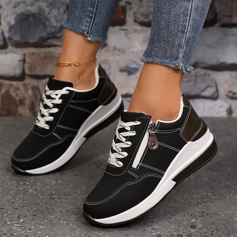 Supportive women's black orthopedic trainers, lace-up low-cut style, providing comfort for active everyday walking.