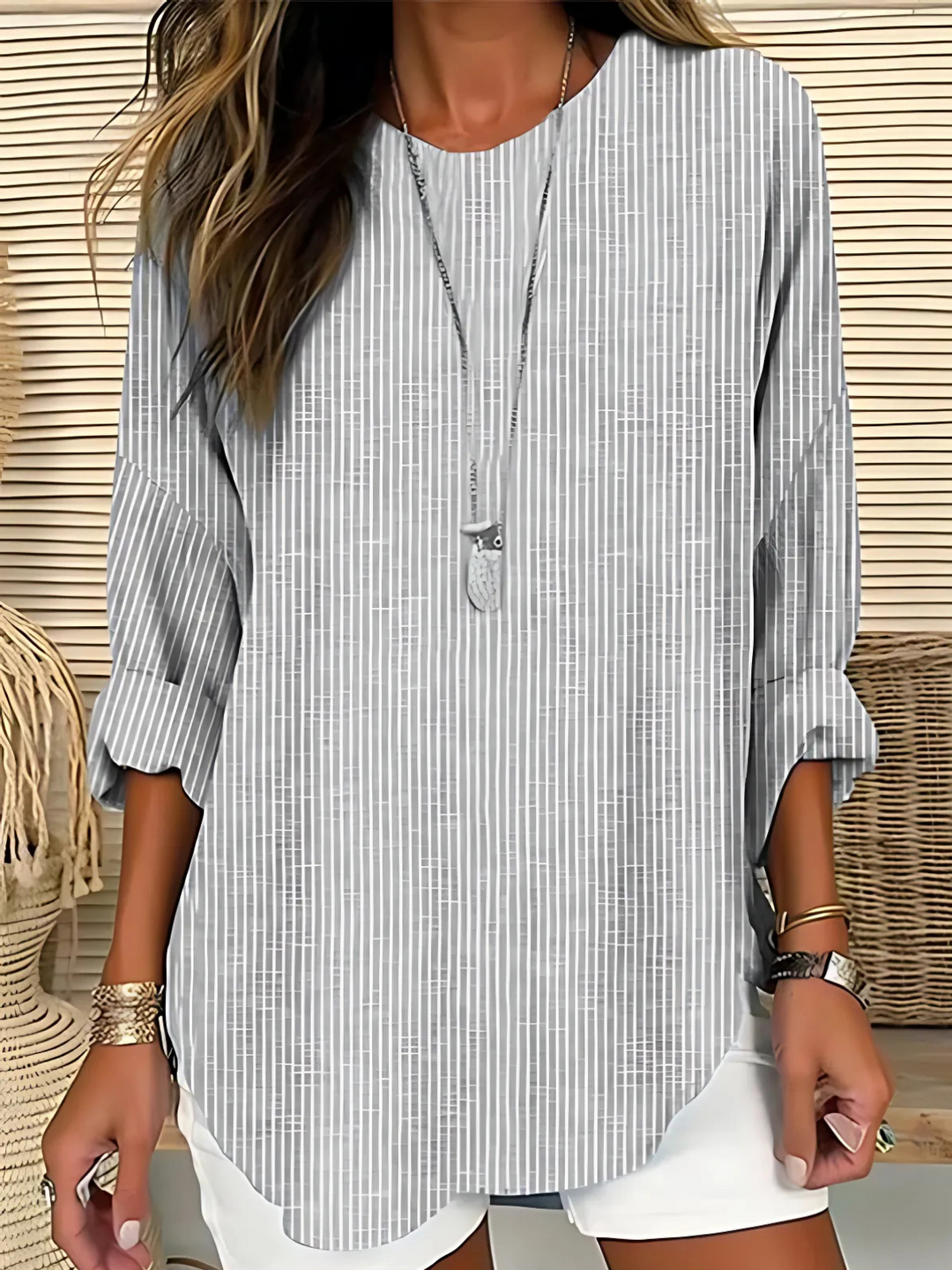 Versatile women's grey striped blouse, relaxed fit crew neck. Effortless casual chic top for everyday comfort.