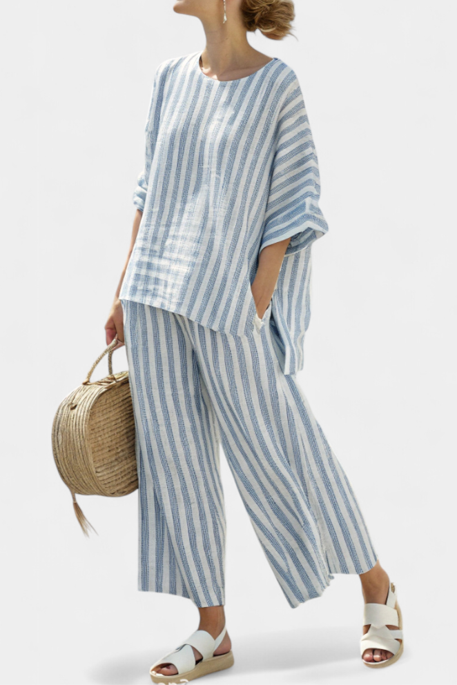 Women's blue striped top and relaxed trousers two-piece set for casual summer wear. Stylish & comfortable vacation outfit.