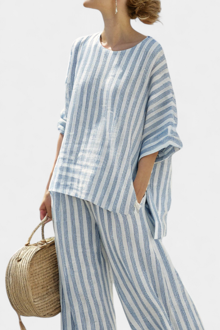 Relaxed fit women's blue striped top and comfortable trousers. Perfect two-piece set for casual summer fashion.