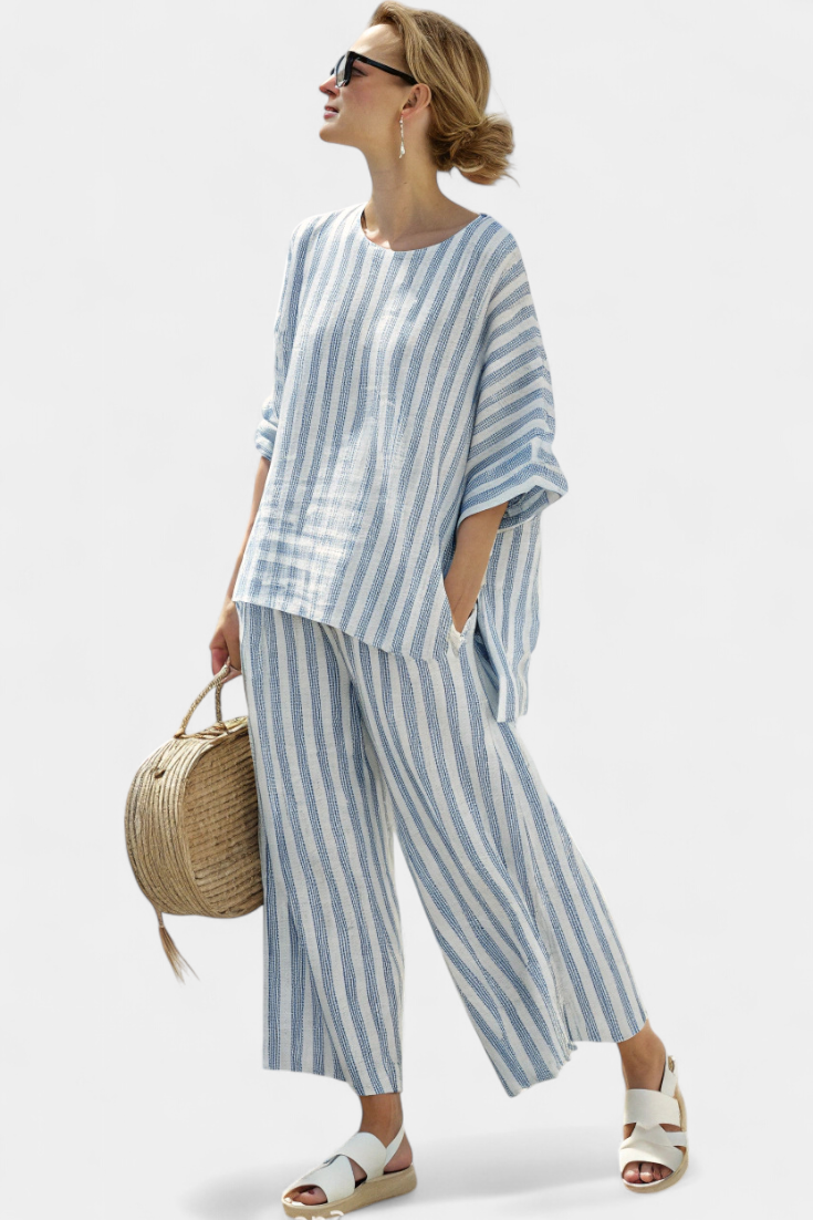 Elegant women's blue striped top and coordinating relaxed trousers. Comfortable two-piece set for summer style.