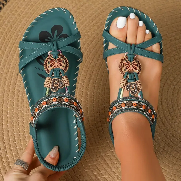 Women's bohemian flat T-strap sandals with intricate beaded embellishments, perfect for summer holidays.