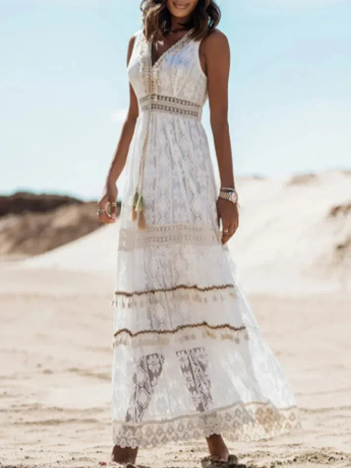 Elegant women's flowing bohemian maxi dress featuring delicate lace accents & stylish flared sleeves. Summer fashion.