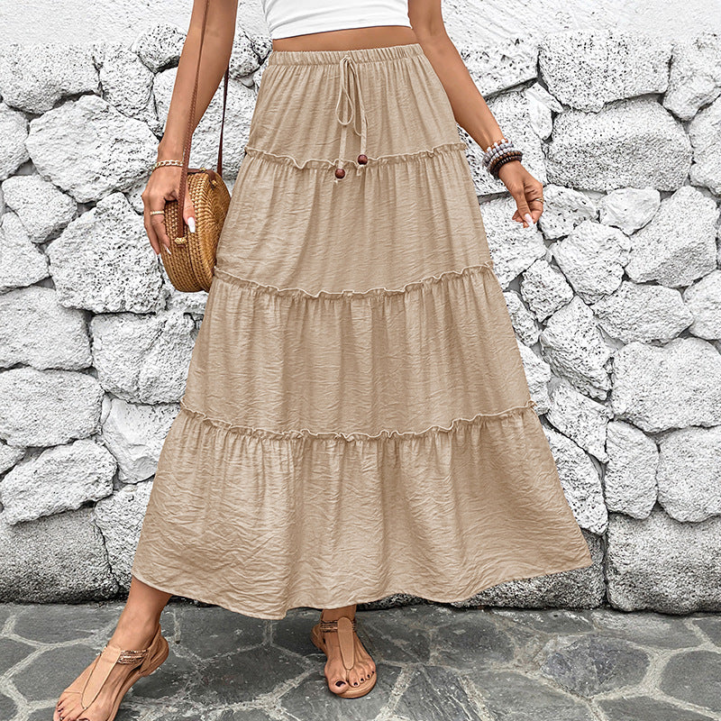 Women's bohemian pleated maxi skirt in flowing kaki fabric, perfect for elegant summer casual wear or vacation.