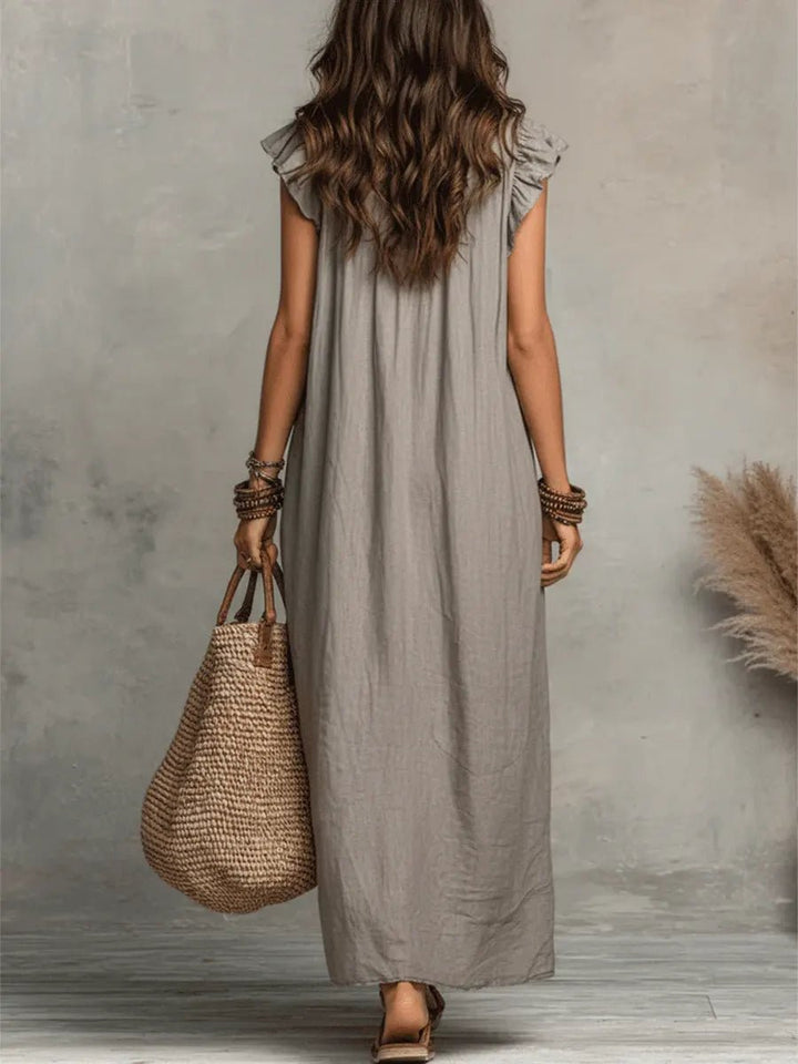 Detailed view of Women's Bohemian Ruffle V-Neck Maxi Dress. Highlights flutter sleeves & flowy fabric.