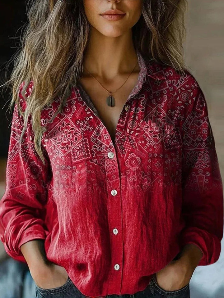 Bohemian women's long-sleeve button blouse with an elegant floral and paisley print for a free-spirit look.