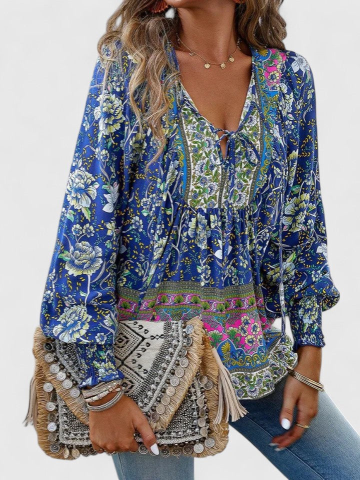 Effortless women's long sleeve boho peasant top with a vibrant floral pattern, great for casual style.