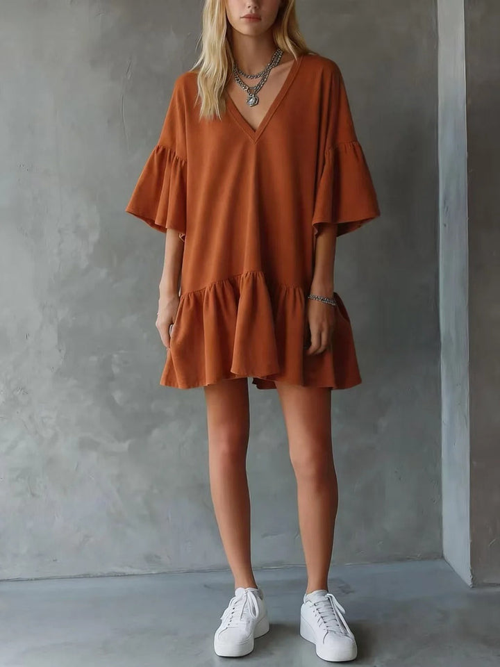 Casual women's flowy midi dress with a colorful floral print. Bohemian style, V-neck, and trendy flutter sleeves.