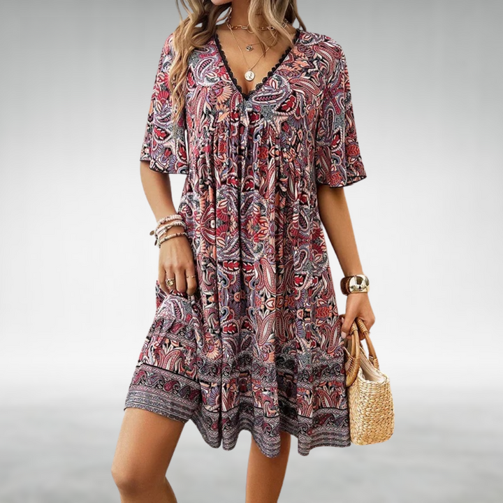 Front view of a chic women's floral boho mini dress. This V-neck summer casual dress has a flattering short cut.