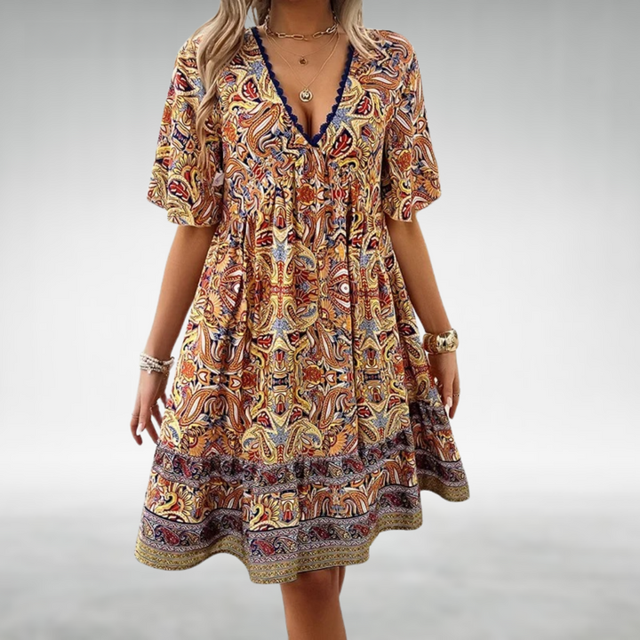 Flowy women's summer boho mini dress featuring a beautiful floral print and V-neck. A comfortable short vacation dress.