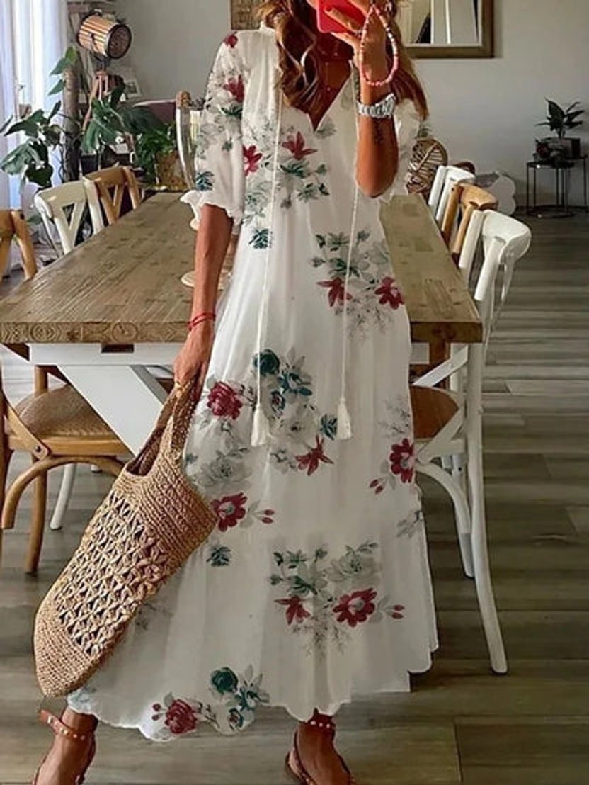 Resort wear women's ikat print V-neck midi dress. Bohemian style with tassel detail, perfect for summer.