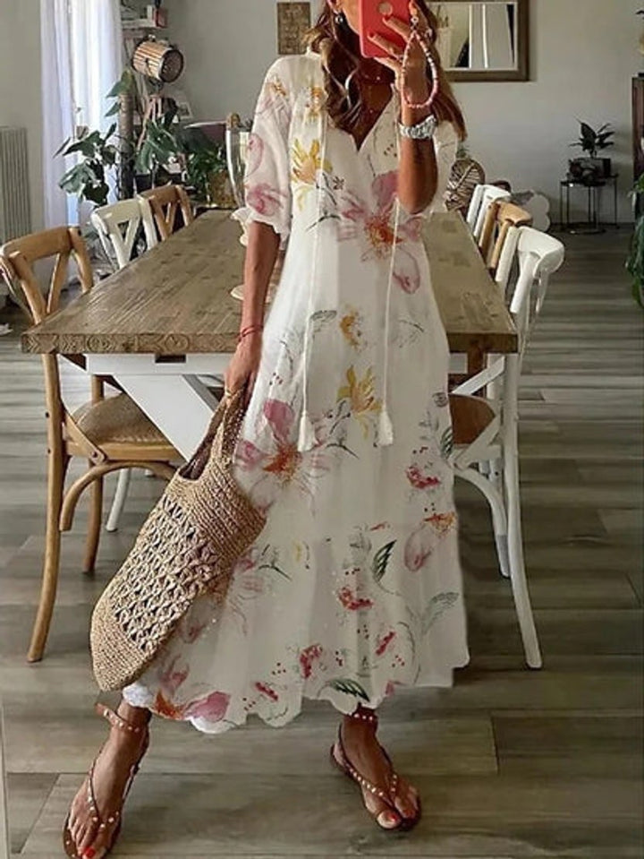 Lightweight women's summer midi dress. Ikat print, V-neck & tassel details for a chic bohemian look.