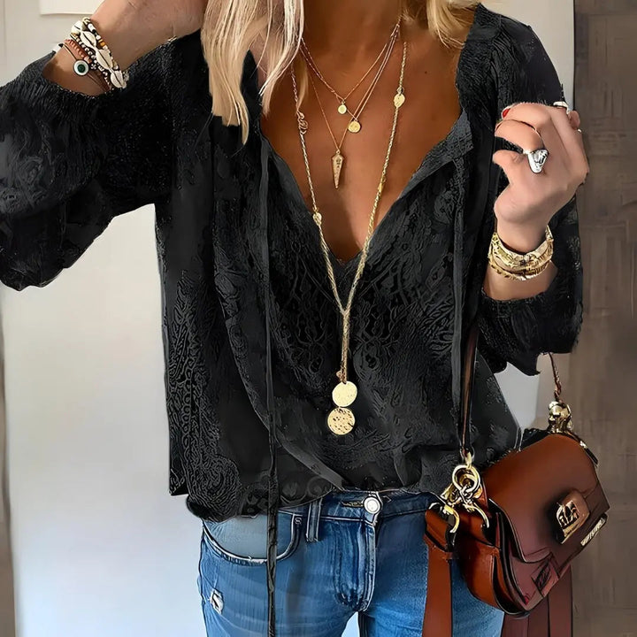 Bohemian women's lace long sleeve blouse, featuring a stylish deep V-neck. Casual yet elegant top.