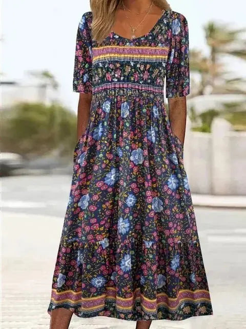 Women's elegant bohemian maxi dress, round neck, short sleeve. Flowing artistic print ideal for summer holidays.