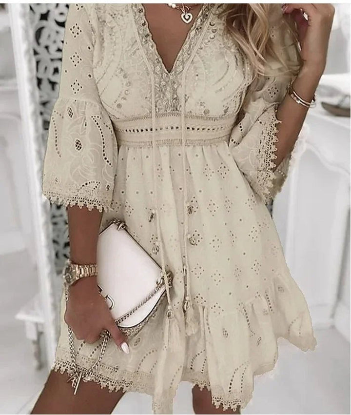 Flowy A-line boho mini dress for women, featuring a chic V-neck & romantic bell sleeves. Great for festivals.