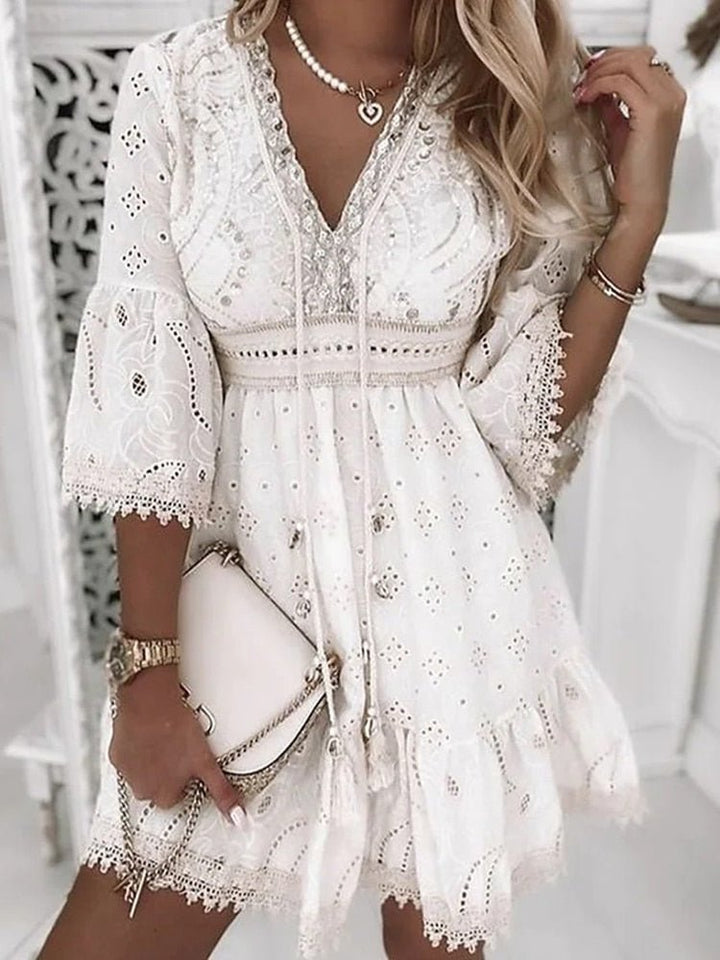 Stylish women's boho mini dress with V-neck & bell sleeves. A-line design, perfect spring/summer fashion & beachwear.