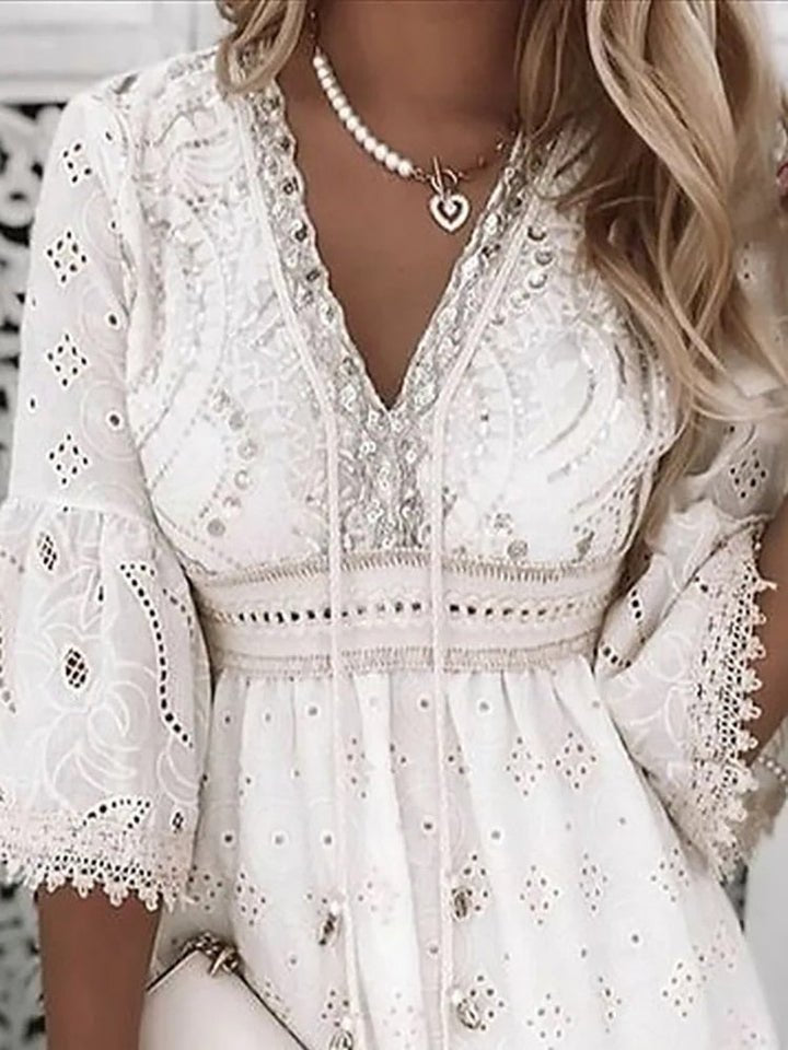 Casual elegance in a women's bohemian mini dress with V-neck, flowy bell sleeves & A-line for vacation.