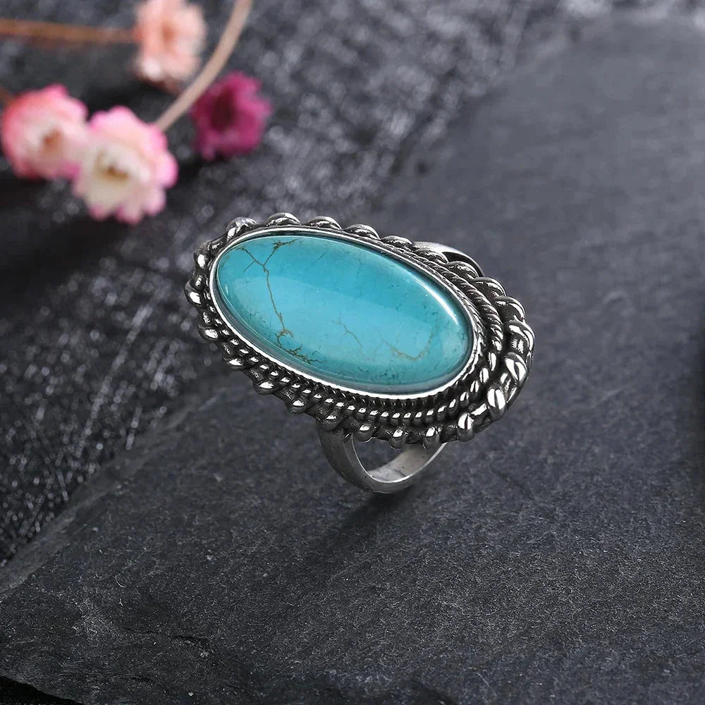 Women's boho oval turquoise ring with a braided silver-tone setting, a unique fashion accessory.