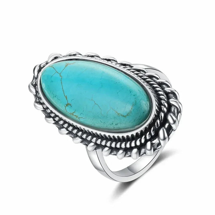Bohemian chic women's oval turquoise ring, featuring a vibrant gemstone and braided silver-tone band.