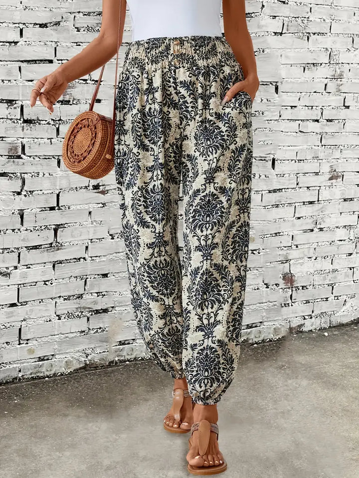 Vibrant boho print wide leg trousers for women, featuring a relaxed fit & elastic waist, great for summer style.