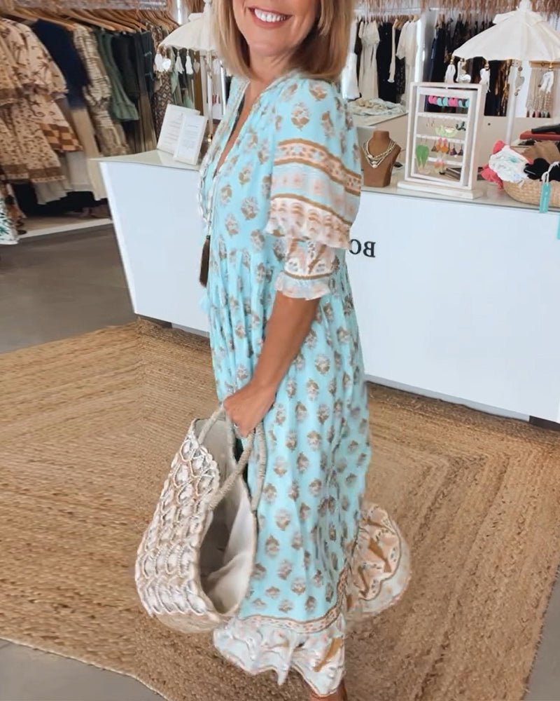 Vacation-ready women's printed midi dress with boho style & tassel ties, ideal for summer fashion.