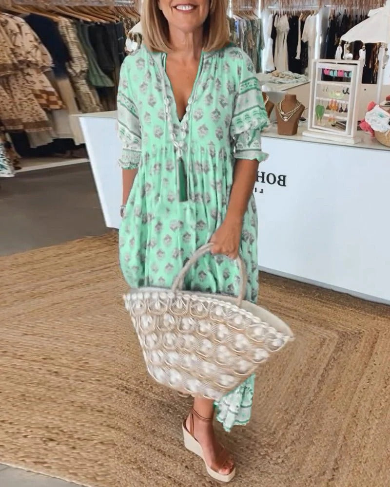 Printed midi dress for women, bohemian style with a comfortable flowy fit and chic tassel tie closure.