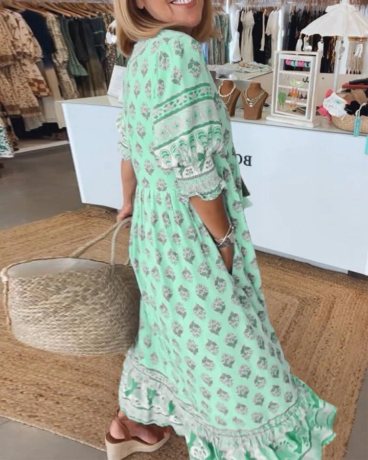 Eye-catching printed midi dress for women, featuring a vibrant boho pattern and elegant tassel tie front.