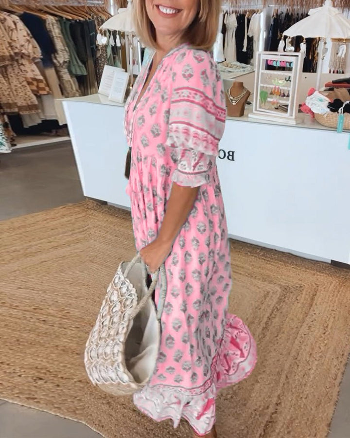 Comfortable flowy women's boho midi dress with vibrant print and delicate tassel tie, a summer essential.