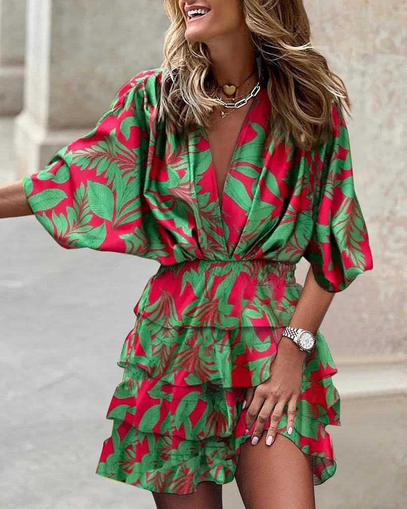 Flowy women's boho mini dress featuring a vibrant print and delicate ruffles, ideal for trendy summer looks.