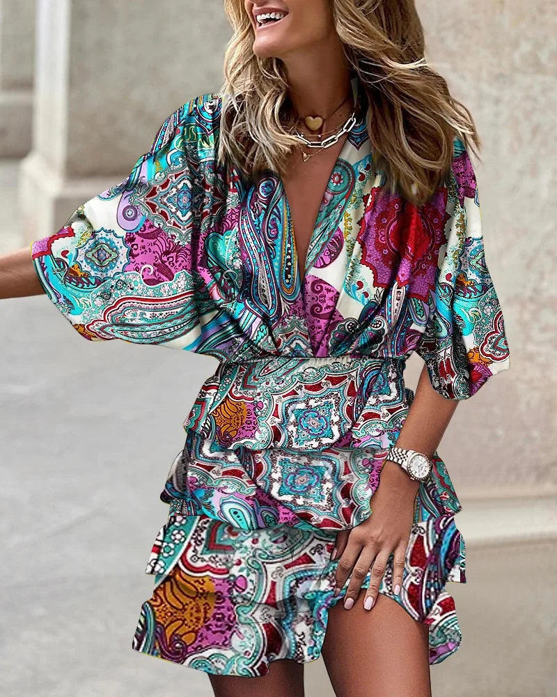 Vibrant women's printed boho mini dress with ruffles & smocked detail, ideal vacation wear for summer getaways.