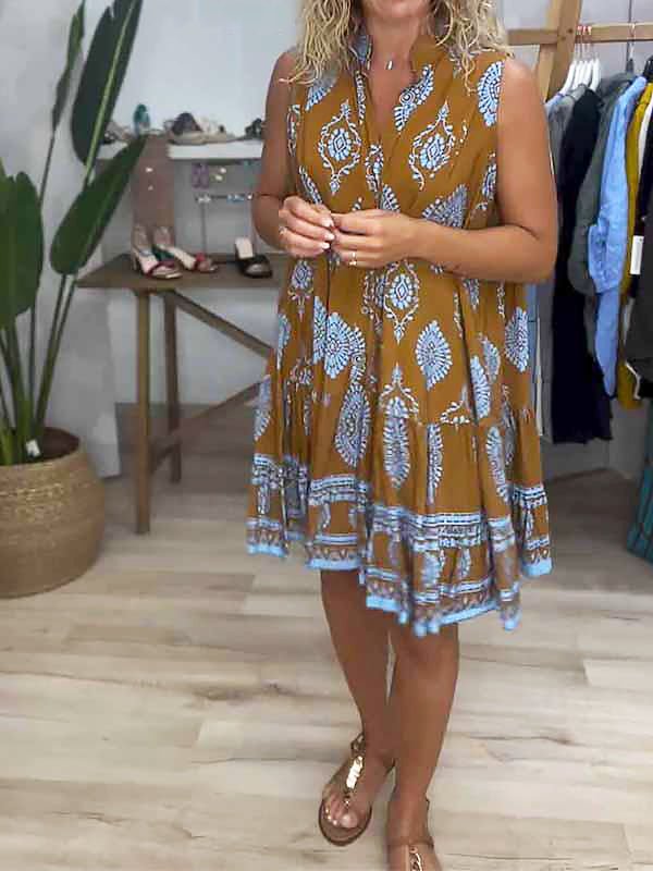 Casual women's sleeveless mini dress featuring a vibrant boho print, ideal for warm weather and beach vacations. Flowy fit.