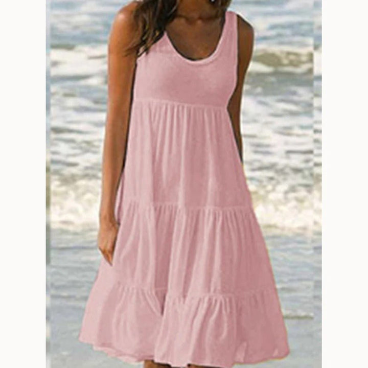 Flowy women's sleeveless tiered midi dress in bohemian style with a scoop neck, ideal for relaxed summer fashion.