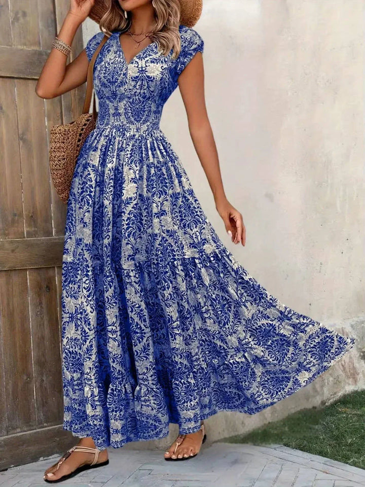 Bohemian tiered maxi dress for women, featuring a smocked bodice, V-neck, and stylish cap sleeves.