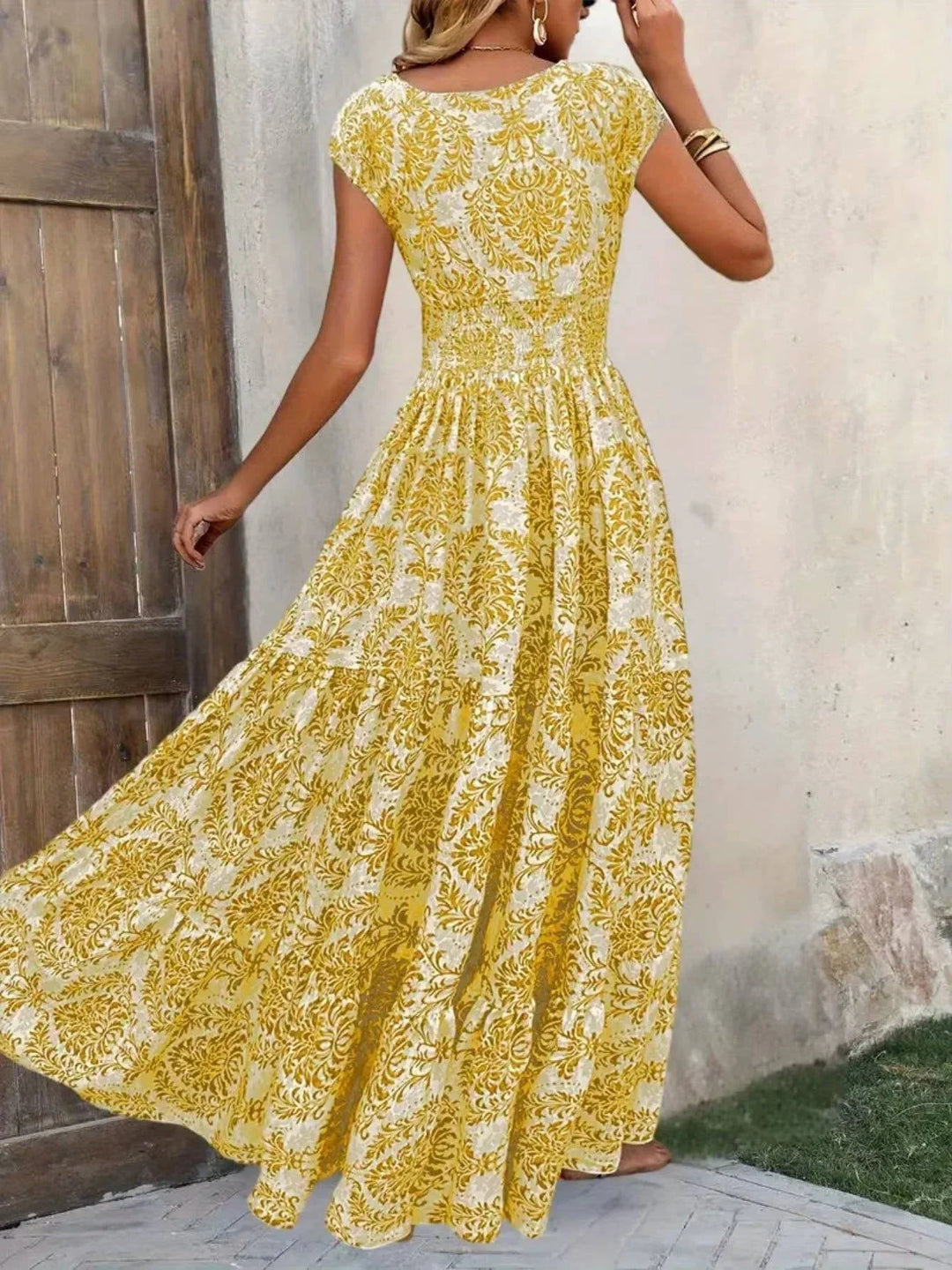 Women's smocked tiered maxi dress, boho style, V-neck, cap sleeves, relaxed fit for summer comfort.
