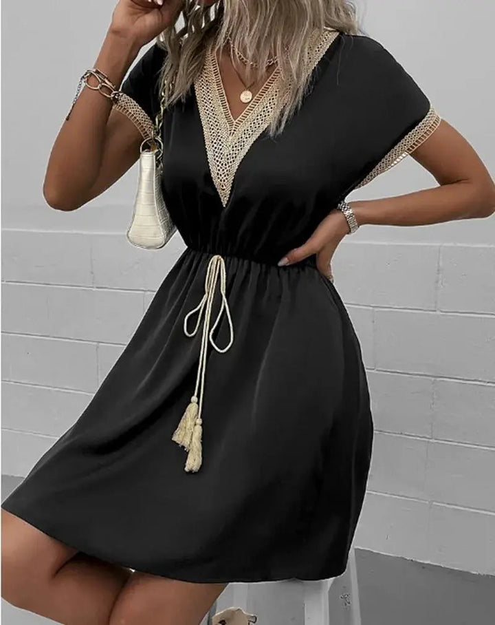 Chic women's flowy V-neck midi dress featuring short sleeves and a stylish tie waist. Ideal for summer.